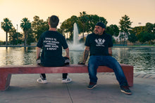 Load image into Gallery viewer, TheGuyWhoDancesOnCongress Trefoil TGWDOC Logo Tee (White Ink on Black Shirt)